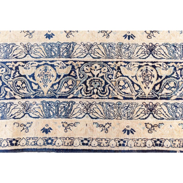 This exquisite antique Persian Kirman rug, dating to the early 20th century, showcases the sophisticated elegance and...