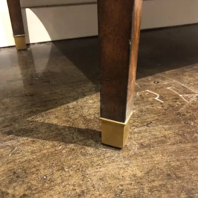 Gorgeous mahogany occasional table with a breakfront brown marble top with canted corners, concealed drawer and brass...