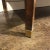 Gorgeous mahogany occasional table with a breakfront brown marble top with canted corners, concealed drawer and brass...