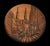 An imaginary view, artfully etched in metal/brass with copper accents, of an antique cityscape with sepulchral buildings...