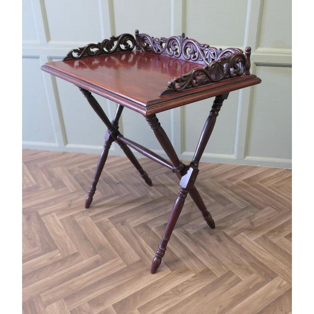 A Decoratively Carved Butlers Table, Tray on Stand This is an attractive piece, it has a floor standing easily collapsable...