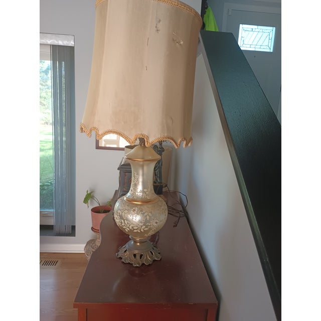 1960s Glamorous Vintage Hollywood Regency/Neo-Classical Iridescent Glass and Brass Table Lamp The lamp is made of...