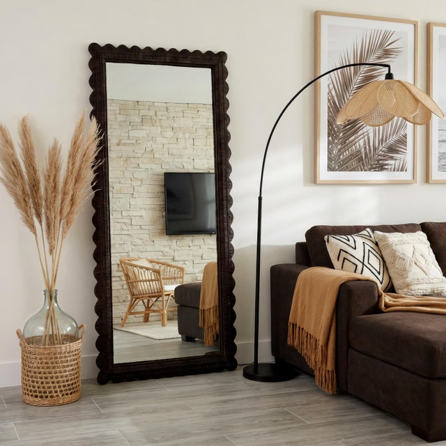 The Butler Specialty Company Flora Full Length Floor Mirror radiates natural charm with its handwoven rattan frame and...