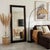 The Butler Specialty Company Flora Full Length Floor Mirror radiates natural charm with its handwoven rattan frame and...