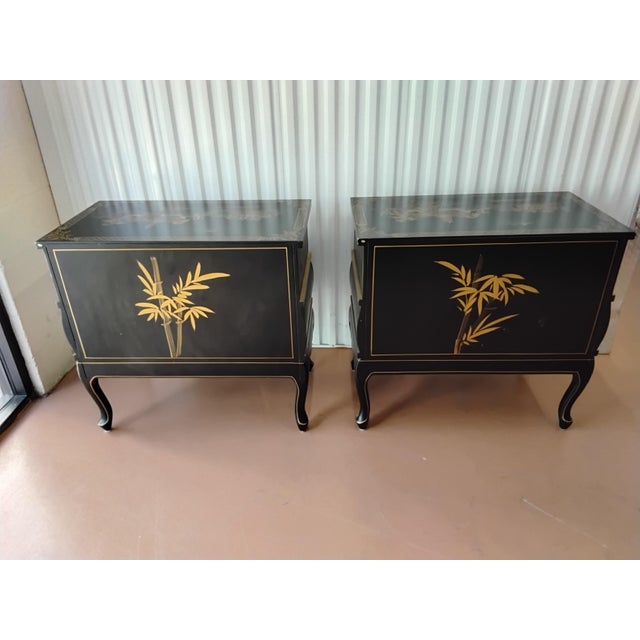 Pair of black and gold chinoiserie chests. They have 2 deep drawers, with ample storage. Perfect addition to any room with...