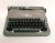 A 1954 Underwood portable typewriter with the original case. The vintage Jewell typewriter is an asparagus green and beige...