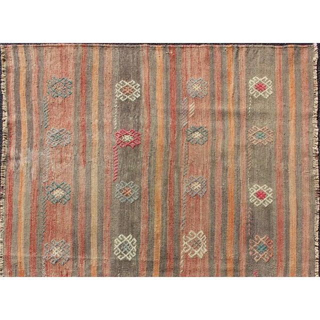 Vertical stripe design flat-weave Kilim from Turkey vintage in orange, red, brown, gray, and cream, rug country of origin...
