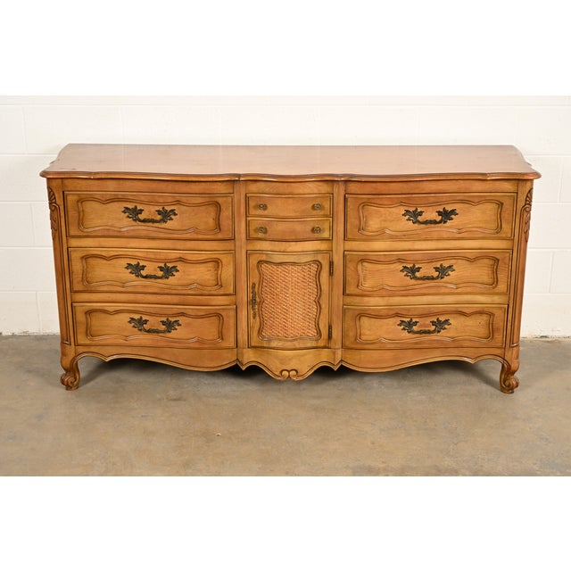 A beautiful French Provincial Louis XV style eight-drawer triple dresser or credenza By Fancher Furniture Company USA,...
