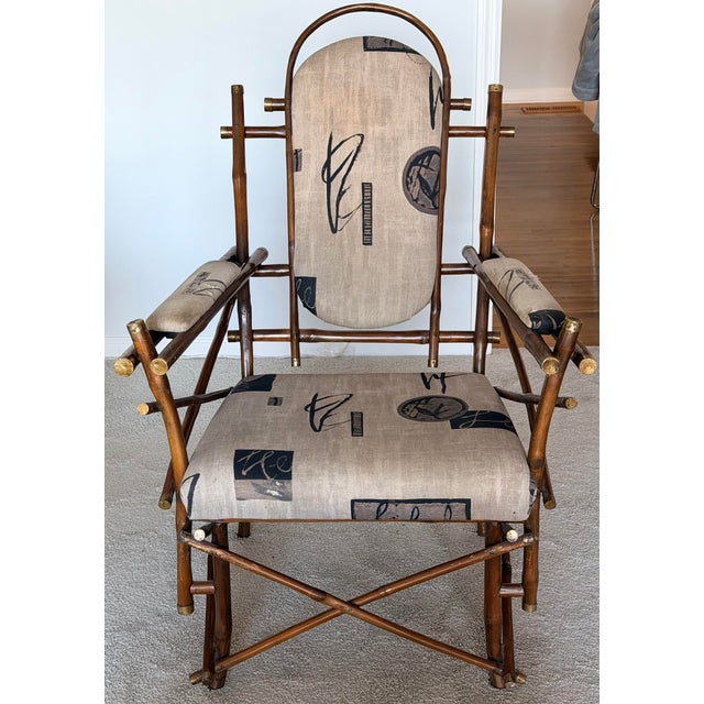 A rare faux bamboo rattan with brass caps chair and ottoman. Made in Italy in the 1970s. Chair and ottoman with original...