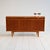 Teak sideboard with three doors and integrated upper drawers, clean lines and slender legs. Model "Primo", manufactured by...