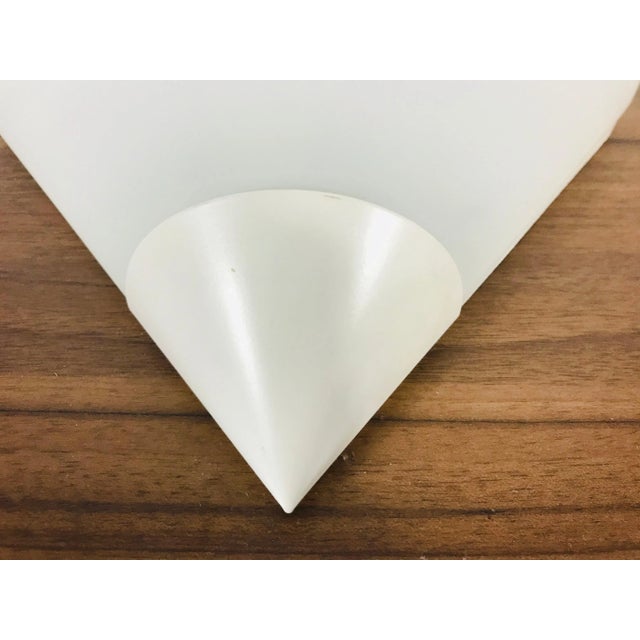 A beautiful Mid-Century Modern wall lamp by Glashütte Limburg made in Germany in the 1970s. It has a beautiful triangle...