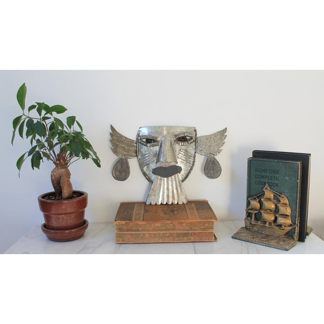 Vintage tin folk art mask. Made in Mexico. Age wear to tin. Will require something to hang on the wall.