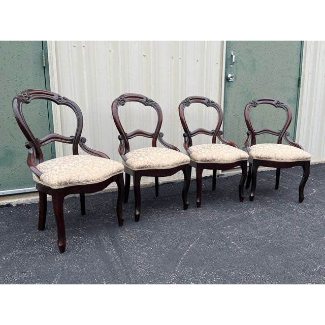 A set of four antique mahogany balloon back chairs. Hailing from the early 1900s, these chairs retain beautiful character...