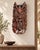 A remarkably expressive vintage Indonesian hand-carved wood wall mask depicting a horned demon or guardian figure, most...