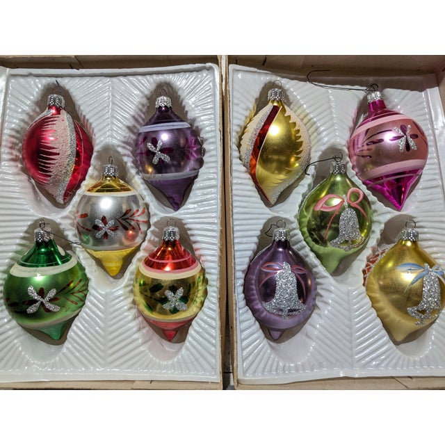 Ten brilliant ornaments in the original boxes. Made in Romania, circa 1970's.