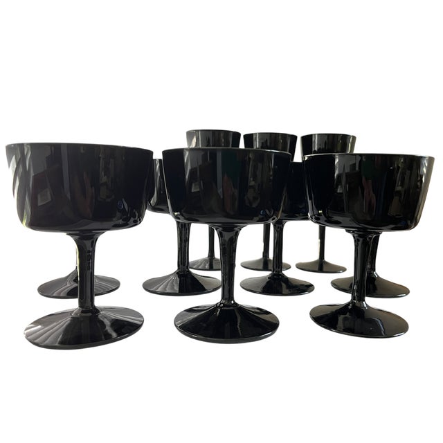 A striking set of Scandinavian Modern stemware by Björkshult, Sweden, rendered in deep black glass with a high-gloss,...