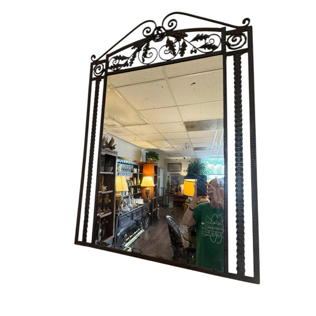 An exceptional wrought iron wall mirror, featuring an elegant hand-forged Art Deco design with acanthus leaf and...