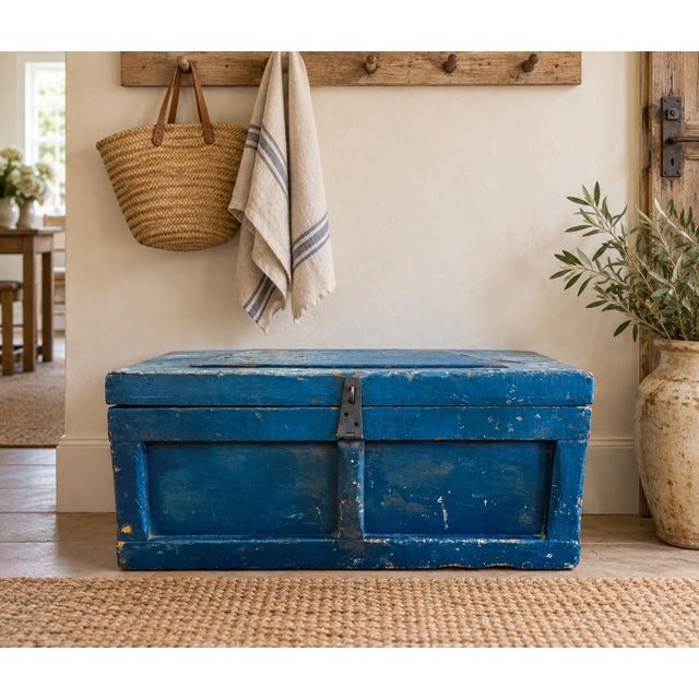 Vintage rustic solid wood trunk with hinged lid and original iron latch. Age has left this beauty with layers of paint...