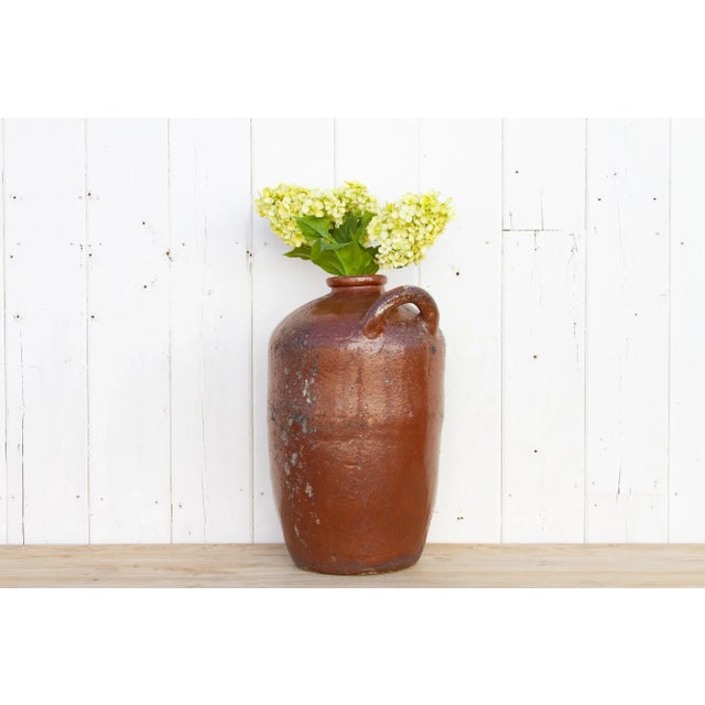 An original early 20th century Spanish terracotta jug used for storing and transportation of wine. This traditional jug...