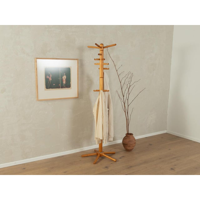 Classic coat rack from the 1980s. High-quality solid pine wood frame with 16 hooks. Made in Germany.