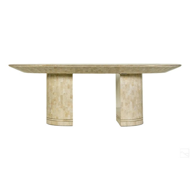 A glamorous dining table designed and retailed by Karl Springer, circa 1980s. The iconic shape features a beveled horse...