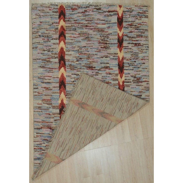 This hand knotted pile rug is crafted from a blend of wool and bamboo silk, featuring a multicolor jewel tone palette. It...