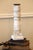 This is a reclaimed, salvaged old baluster that has been converted into a candleholder. Attached to the wood square base...