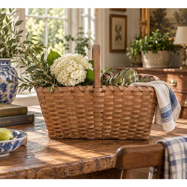 A beautifully woven early 20th century American splint oak basket with warm honeyed tones and a tightly constructed...