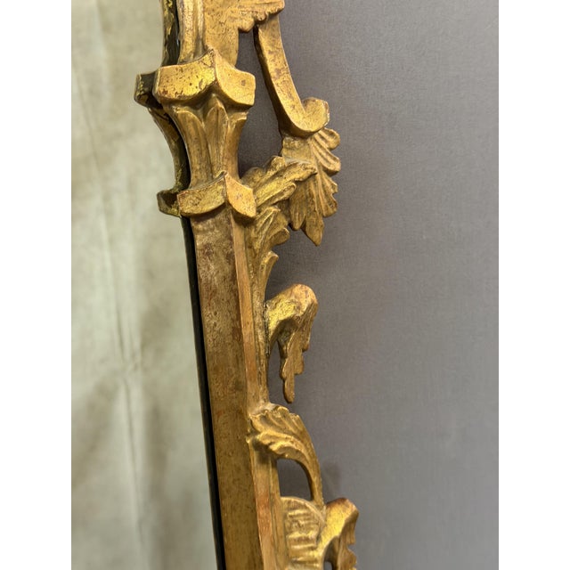 Late 19th-century Italian mirror in giltwood, decorated in the Rococo style with foliage. Mirror dimensions: 59 x 43 cm