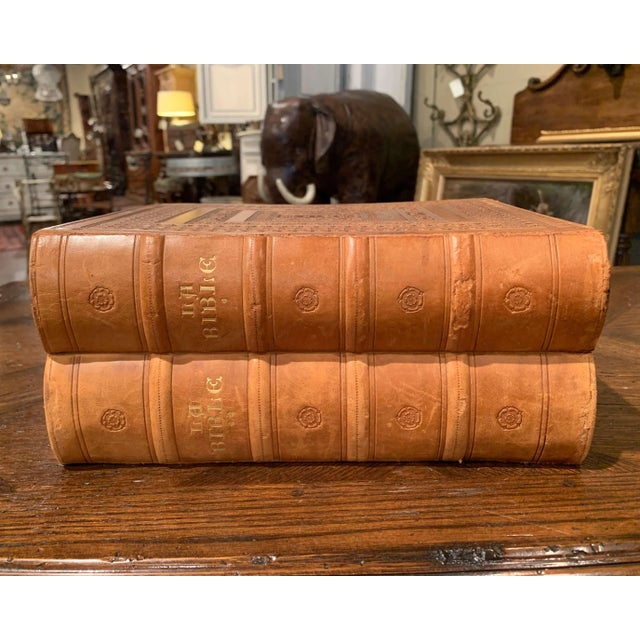 These two holy Bible books with brown leather covers were created in Marseille, France, dated 1953, each of the two books...