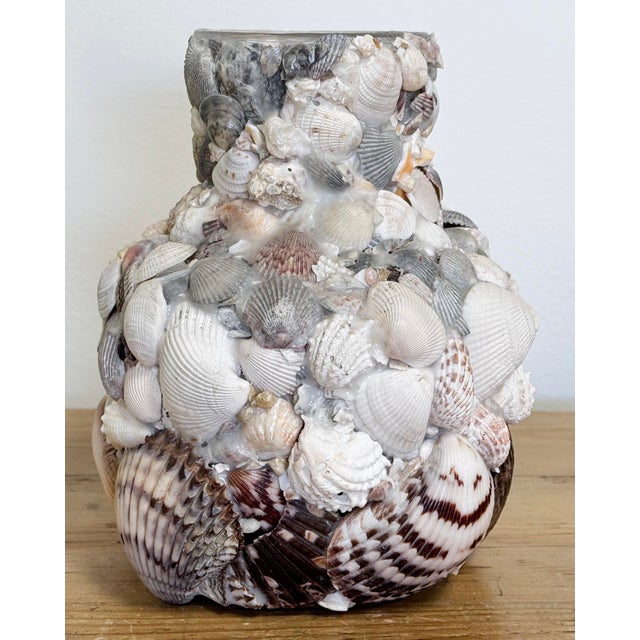 Vintage handmade shell encrusted vase or vessel with unique, varied shells. Age wear. No breaks to glass. Minor breaks to...