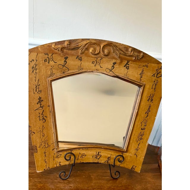 This mirror displays the unique chinoiserie appearance with intricate carved fretwork at the arched top and extensive...