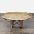 Brass etched tray table, hand tooled in exquisite foliate designs, with a hammer folded pie-crust edge. The tabletop rests...
