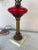 1930's/ 1940's Table lamp. Red glass body and brass elements.Square marble base. Has vintage cloth corded table lamp that...