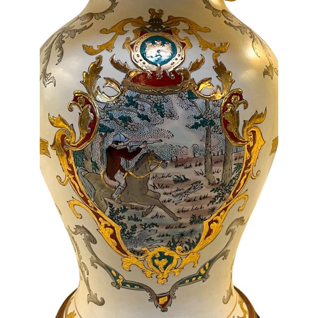A true collector’s piece, this 19th Century Sèvres-style vase, adorned with a fox hunt scene, gilt handles and heraldic...