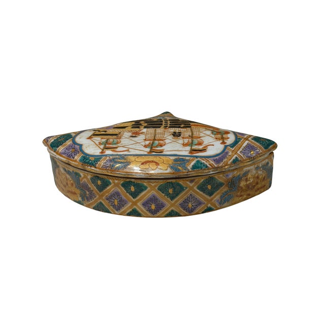 Molded in the distinctive shape of a folding hand fan, this vintage porcelain trinket box features a finely detailed...
