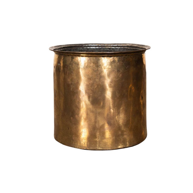 Brass pot with shaped lip. Textured surface.