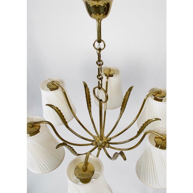 Six arm chandilier from Josef Frank, produced in the 1950's. Completely made of brass with a lovely patina. The shades...