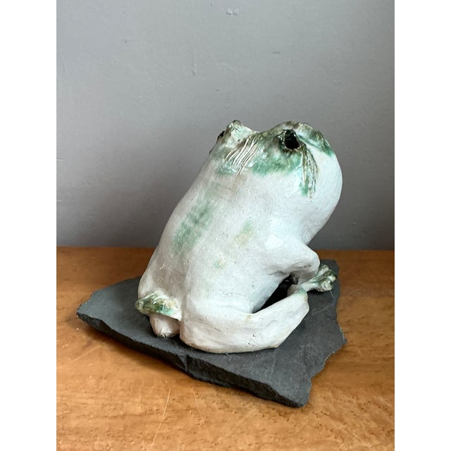 This vintage ceramic frog sculpture reflects an Organic Modern sensibility, its sculpted form capturing the animal in a...