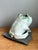 This vintage ceramic frog sculpture reflects an Organic Modern sensibility, its sculpted form capturing the animal in a...