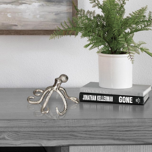 The beautifully sculpted arms of this lovely sea creature appears to be raised up and crawling along your shelf of table....