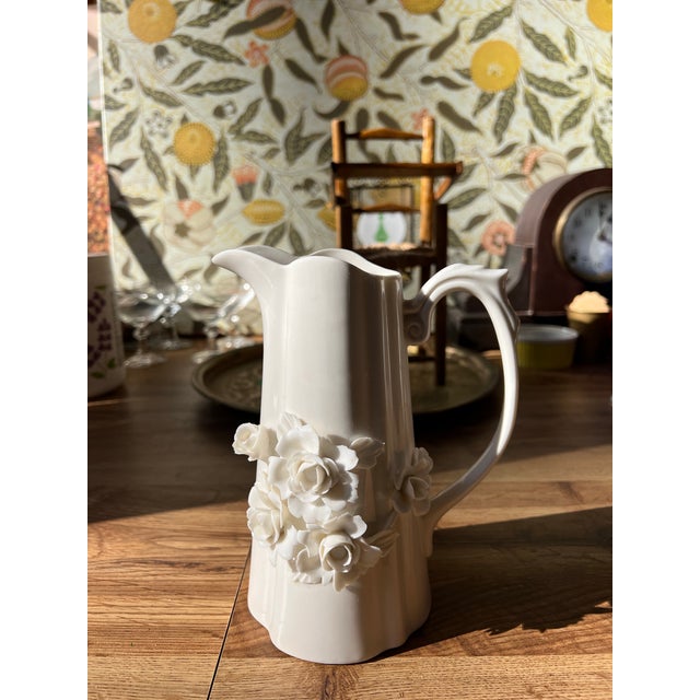 Up for consideration is a beautiful vintage white ceramic floral pitcher. This would look lovely in your home and it is a...