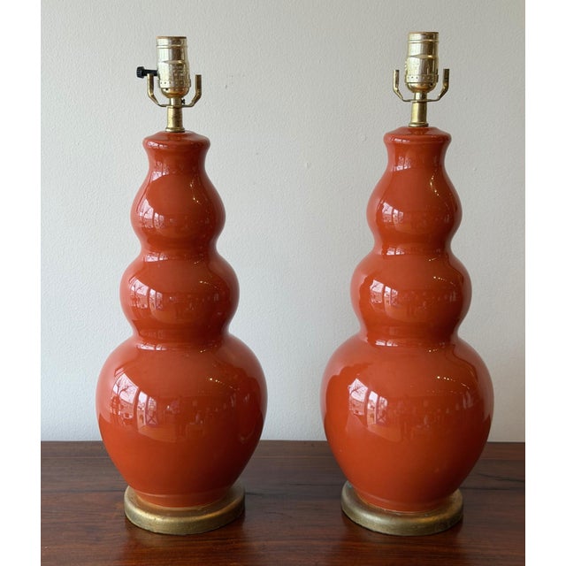 A sculptural pair of vintage triple-gourd ceramic table lamps by Festoni, finished in a rich paprika-toned high-gloss...