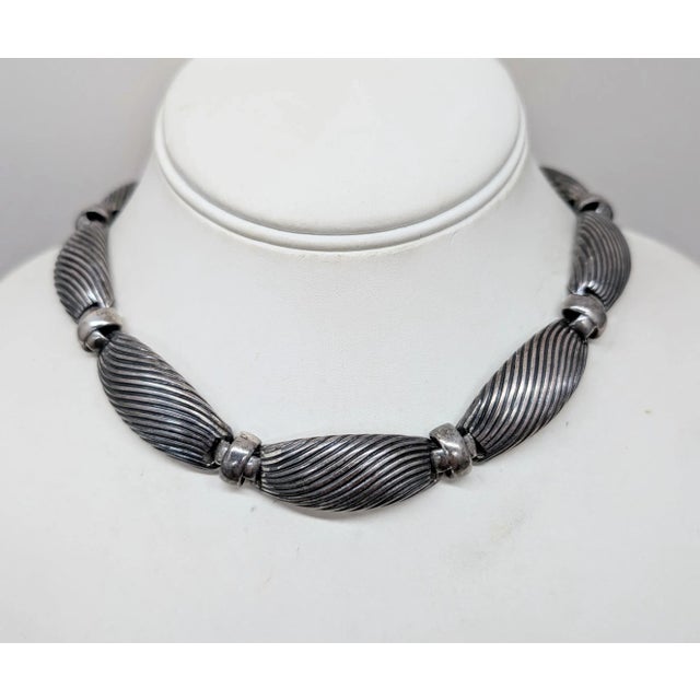 1950s silvertone ribbed sections with x connectors collar necklace with spring ring clasp. Marked "NAPIER" on the section...