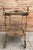 This elegant bronze bar cart dates from the mid-20th century and is inspired by classic French decorative traditions. The...