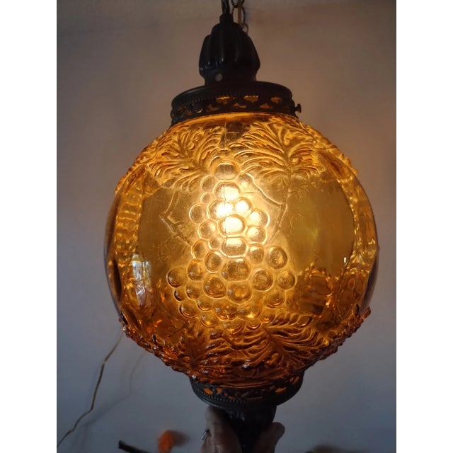Classic Mid Century Amber corded swag light. Grape leaf pattern on glass,