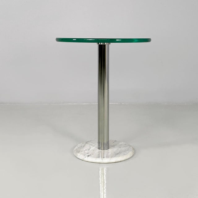 Italian modern round coffee table in glass, steel and marble, 1980s Coffee table with a thick round glass top. The...