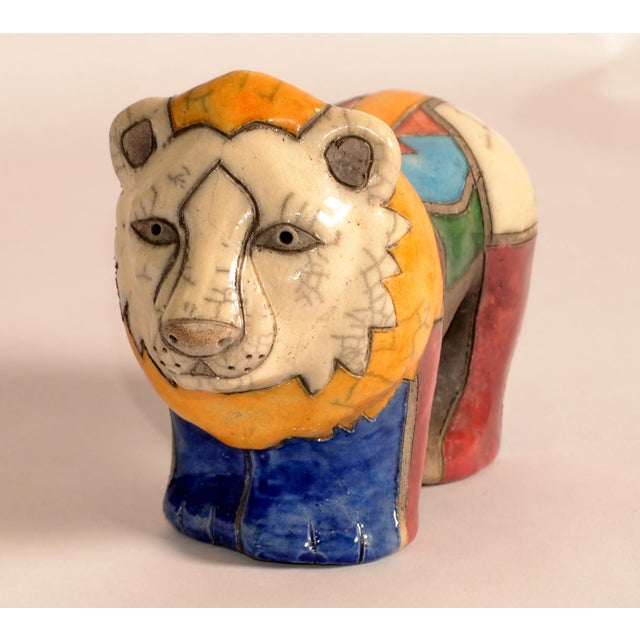 Raku Pottery Lion Figurine crafted in South Africa, featuring a multicolored design with yellow, blue, green, and red...