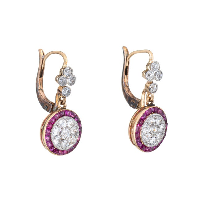 Stylish old mine cut diamond & ruby drop earrings crafted in platinum topped 14k yellow gold. Old mine cut diamonds total...