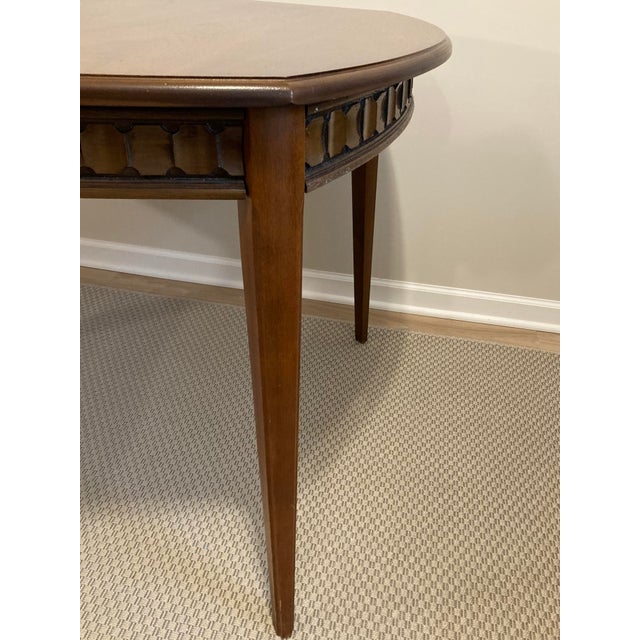 With its curved, alternating geometric detail, this mid-20th century table by Consolidated Furniture Company of Lenoir,...